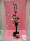 3 red & 1 pink rose, black stand, pink background